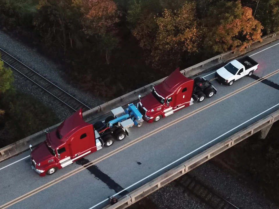 Coldiron Companies transportation expert team transporting two semi trucks and one pickup truck